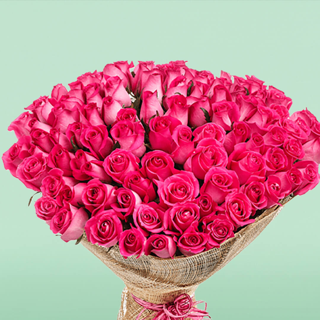 Bouquet of 50 pink roses wrapped in natural jute and tied with a pink ribbon