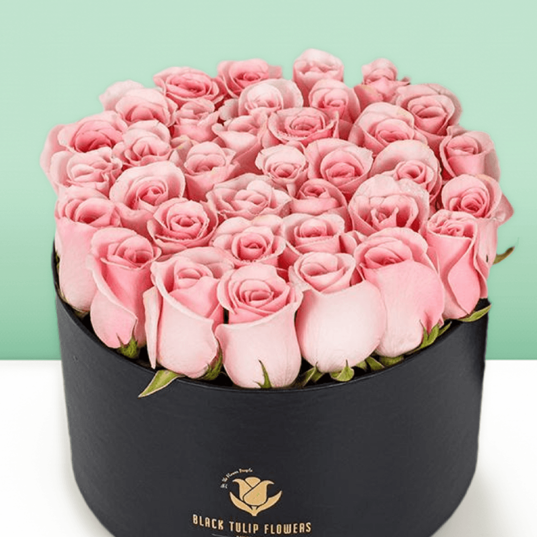 Round flower box featuring 40 to 45 pink roses in a premium black medium round box.