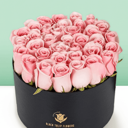 Round flower box featuring 40 to 45 pink roses in a premium black medium round box.