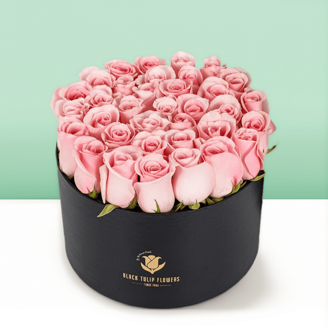 Round flower box featuring 40 to 45 pink roses in a premium black medium round box.