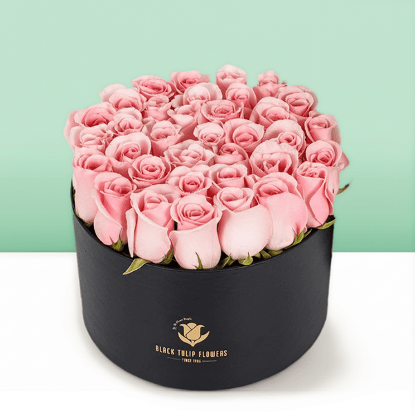 Round flower box featuring 40 to 45 pink roses in a premium black medium round box.