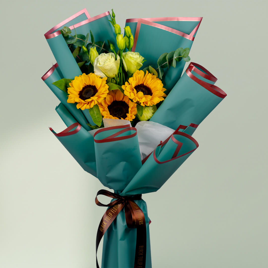 Sunflower bouquet with white roses, Eustoma and greenery wrapped in stylish teal floral paper.