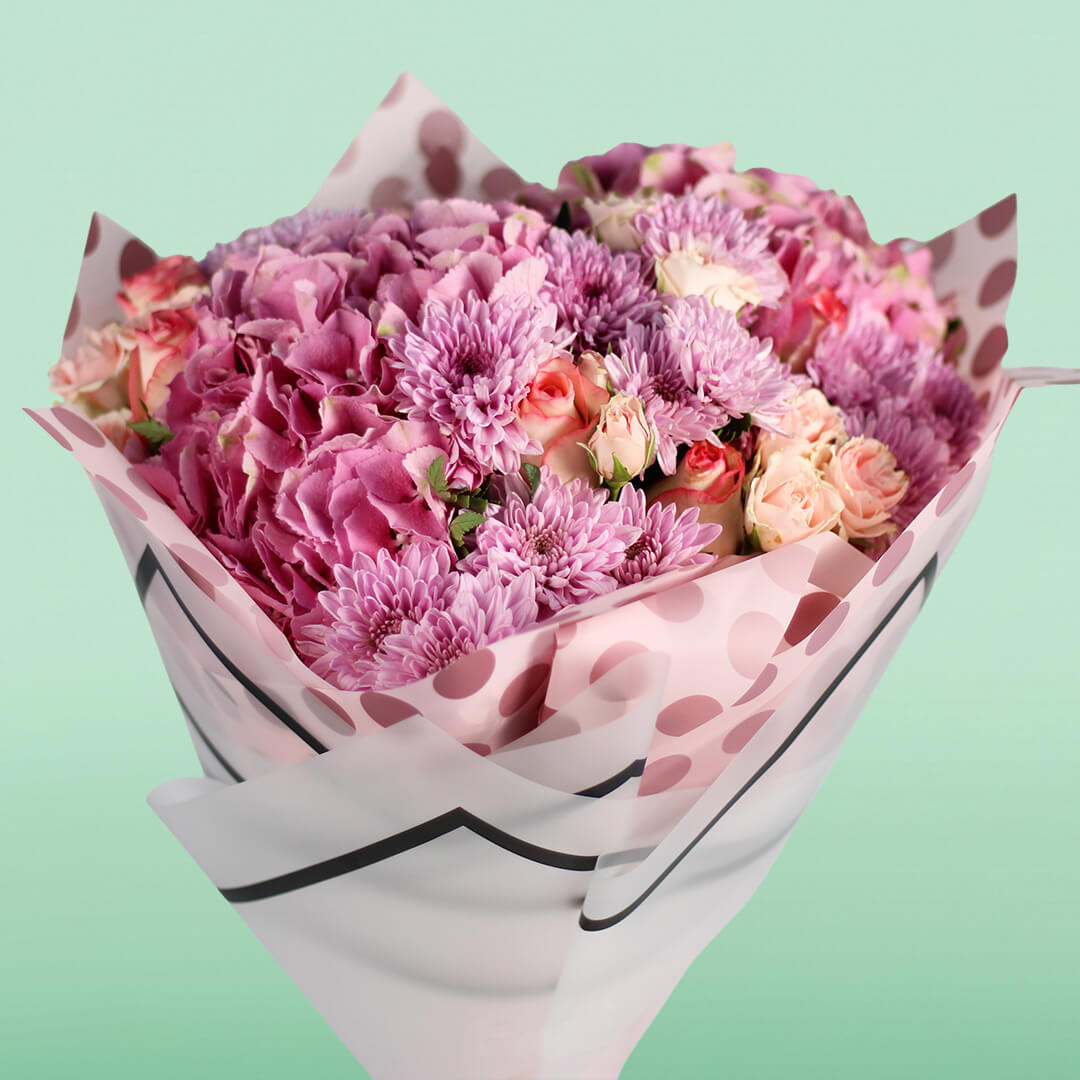 Pink Hydrangeas, Roses, Spray Roses and Chrysanthemums wrapped in Korean-style flower sheets.
