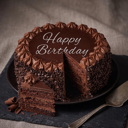 Chocolate truffle cake featuring smooth chocolate ganache, piped frosting, fresh berries and decorative chocolate pieces.