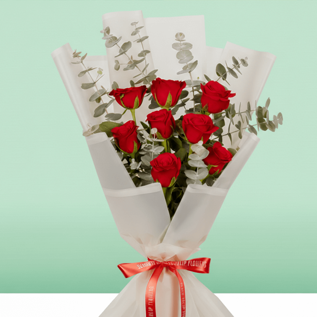 Bouquet of 8 pink roses with eucalyptus wrapped in non-woven paper.