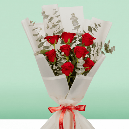 Bouquet of 8 pink roses with eucalyptus wrapped in non-woven paper.