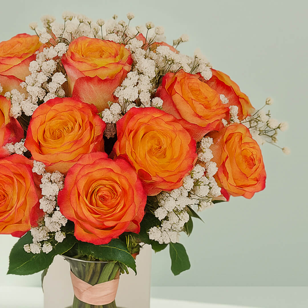 Orange Roses in Glass Vase arranged with 20 orange roses, gypso and fresh greenery