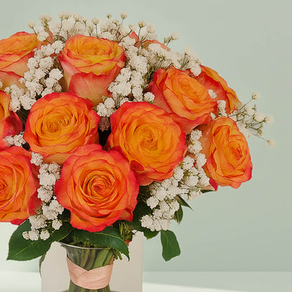 Orange Roses in Glass Vase arranged with 20 orange roses, gypso and fresh greenery
