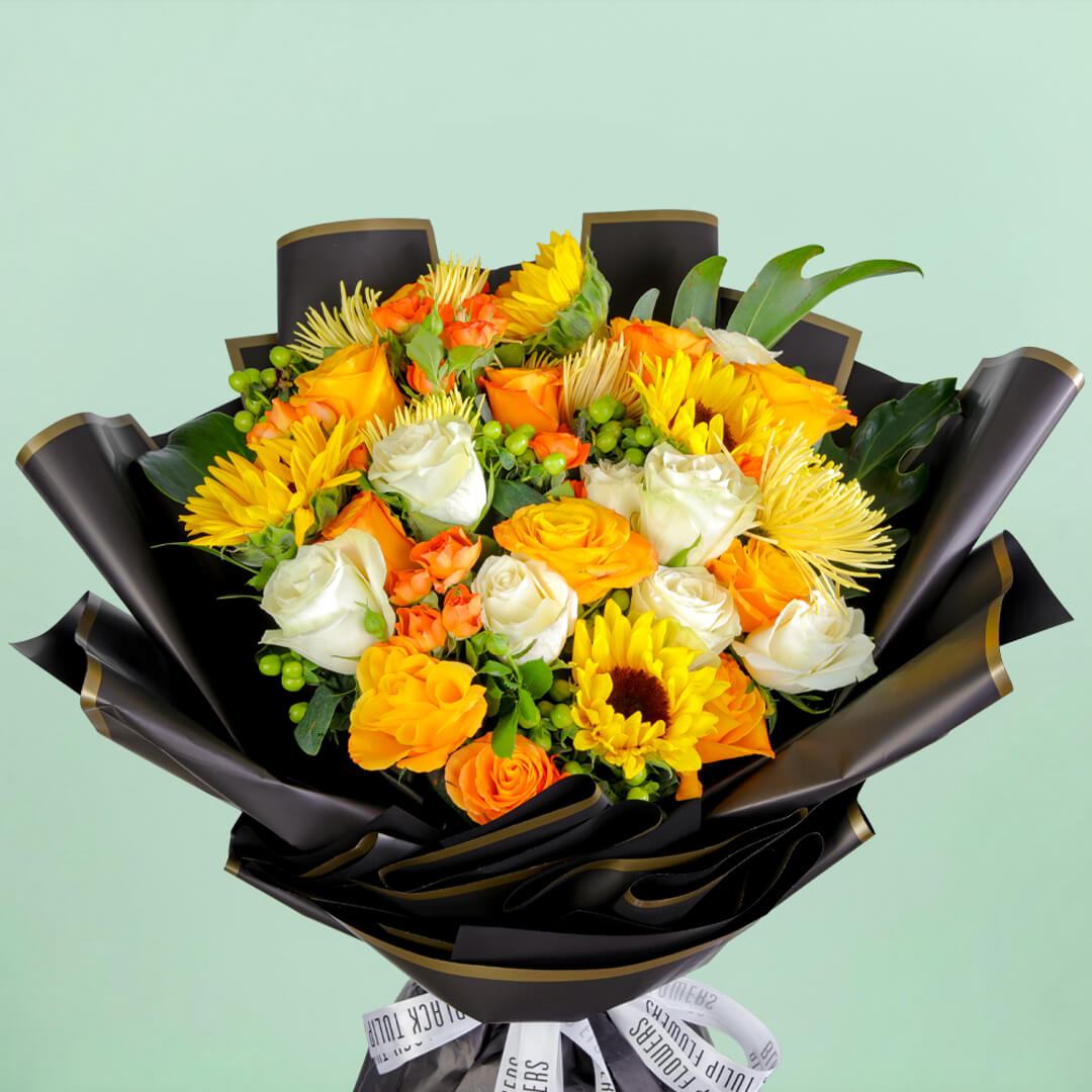 Bouquet with sunflowers, roses, spray roses, disbuds, hypericum, and green fillers in black wrapping
