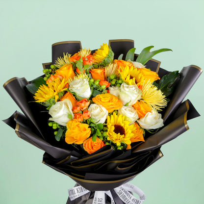 Bouquet with sunflowers, roses, spray roses, disbuds, hypericum, and green fillers in black wrapping