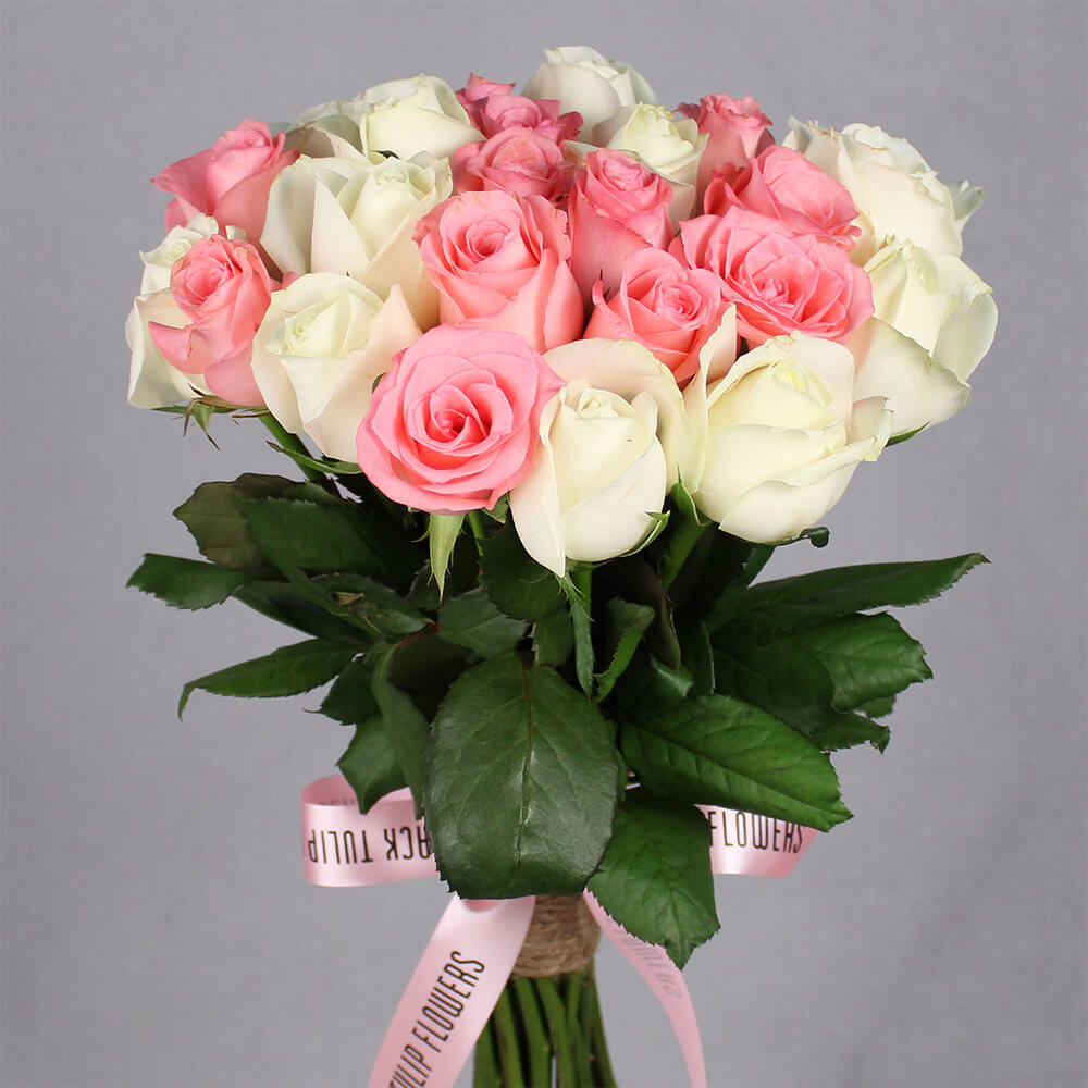 Pink and white Roses bouquet with greenery, one Peacock Rakhi and a box of 16 Ferrero Rocher chocolates.

