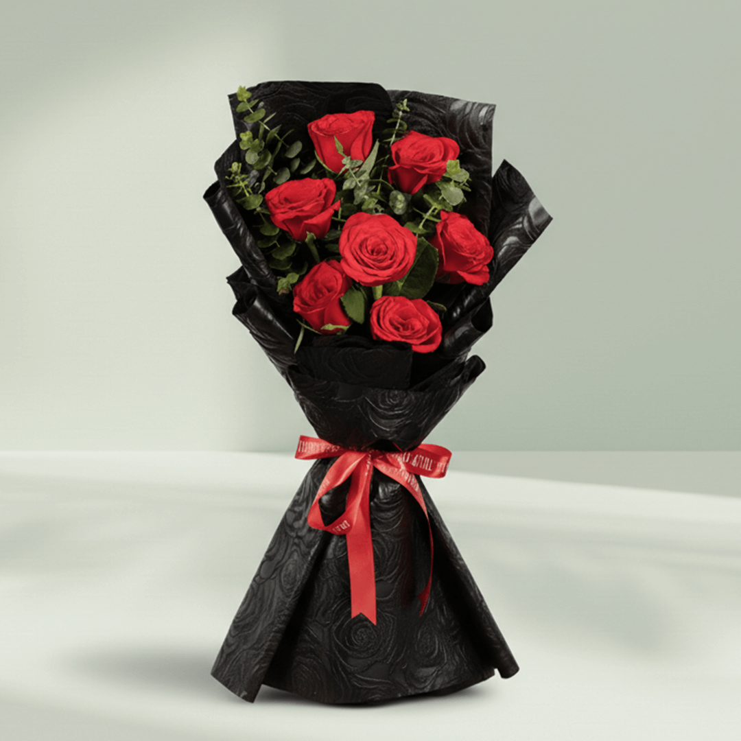 7 red roses bouquet with eucalyptus in black wrapping