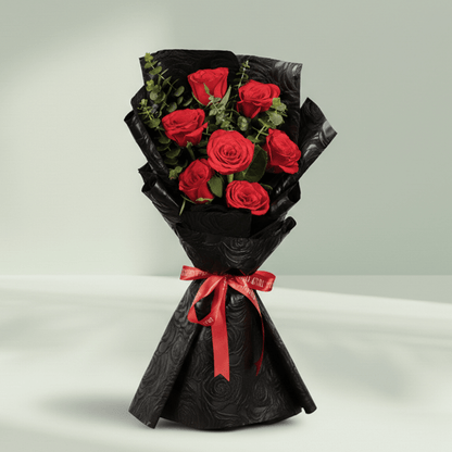 7 red roses bouquet with eucalyptus in black wrapping