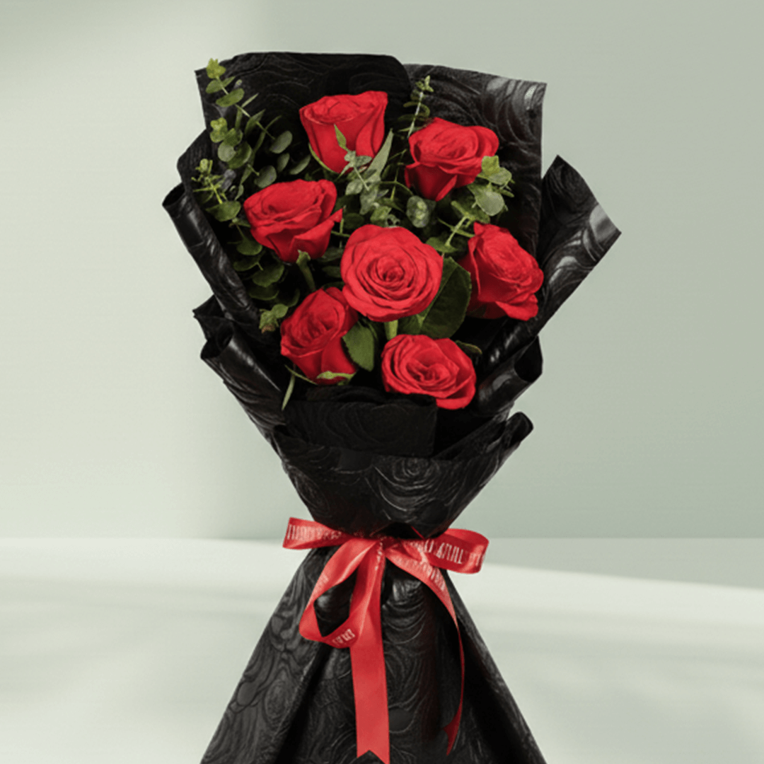7 red roses bouquet with eucalyptus in black wrapping
