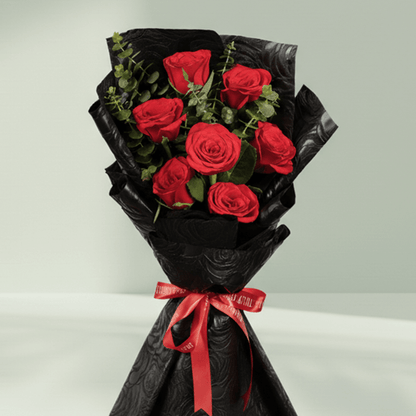 7 red roses bouquet with eucalyptus in black wrapping