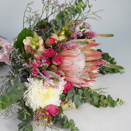 Assorted bouquet with King Protea, Spray Roses, Disbud Chrysanthemums, Veronica, Snapdragons and fresh greenery.