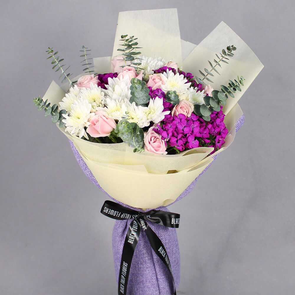 Assorted Chrysanthemums, Roses and Sweet Williams bouquet with Meenakari Rakhi and four Ferrero Rocher chocolates.
