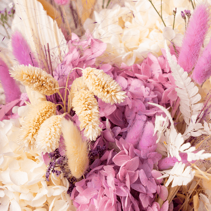 Arrangement featuring assorted dried and preserved flowers in white round box.
