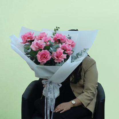 A beautiful bouquet of fresh pink roses, elegantly arranged with delicate foliage and wrapped in soft non-woven paper. The graceful pink colour makes it a thoughtful gift for birthdays, anniversaries, congratulations or heartfelt surprises.