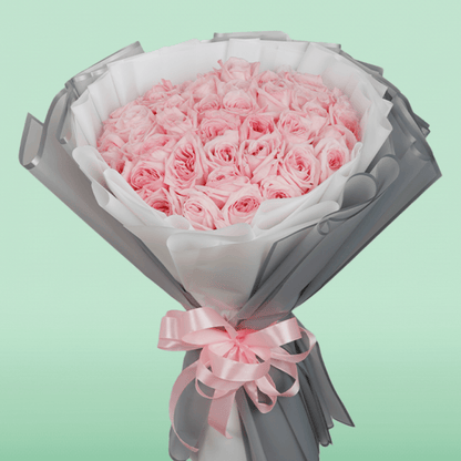 Large bouquet of 50 light pink roses in layered grey and white non-woven wrapping
