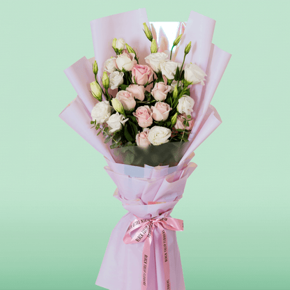 Pink Roses and white Eustoma in soft pink Korean-style wrapping with a decorative “Mom” topper.