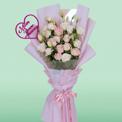 Pink Roses and white Eustoma in soft pink Korean-style wrapping with a decorative “Mom” topper.