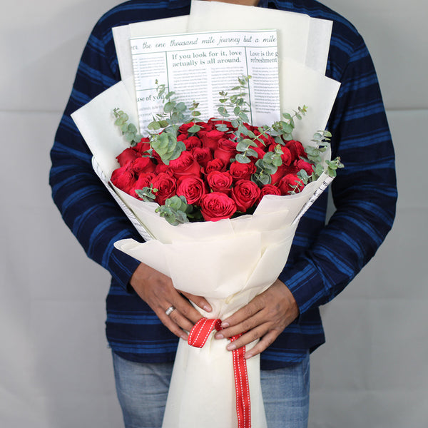 Premium bouquet of 40 red roses with fresh greenery wrapped in white non-woven paper
