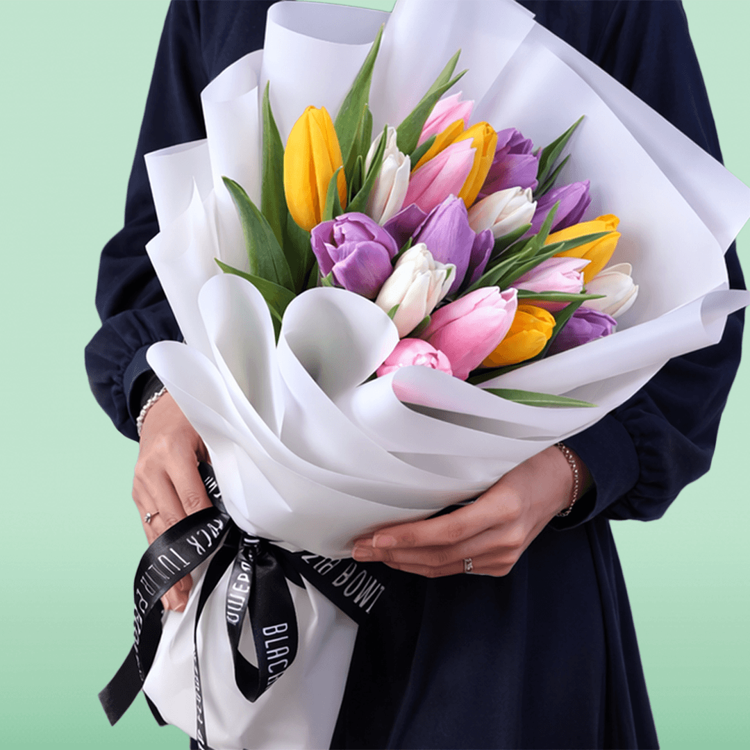 Mixed fresh tulip bouquet with assorted colored tulips and elegant wrapping.