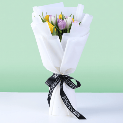 Mixed fresh tulip bouquet with assorted colored tulips and elegant wrapping.