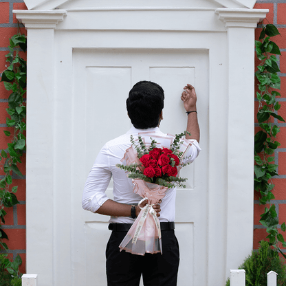 A bouquet of 15 red roses with Eucalyptus wrapped in Korean-style flower sheets.