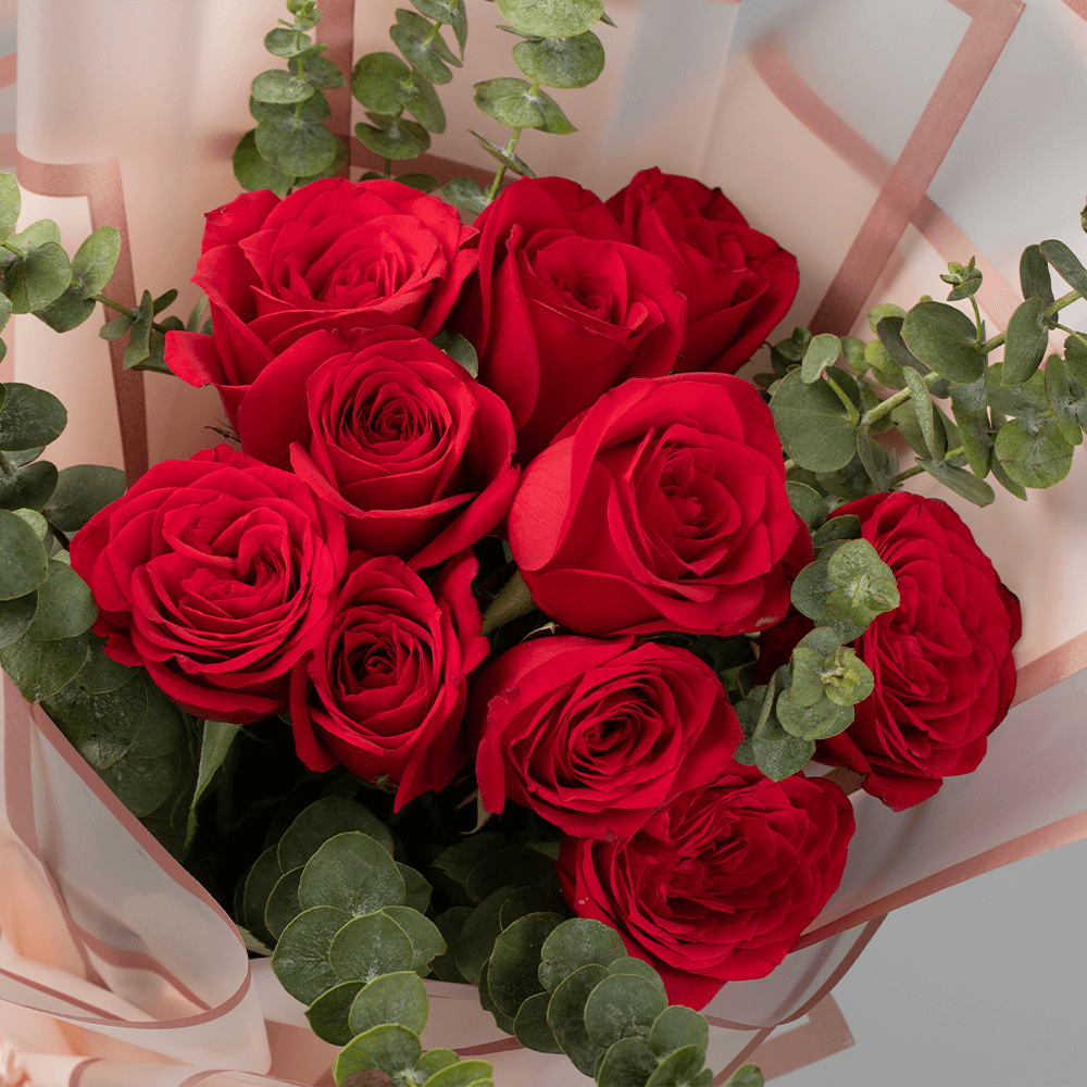 A bouquet of 15 red roses with Eucalyptus wrapped in Korean-style flower sheets.