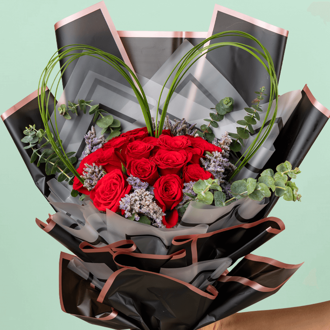 Bouquet of 25 red roses with steel grass, Limonium, and eucalyptus in black wrapping