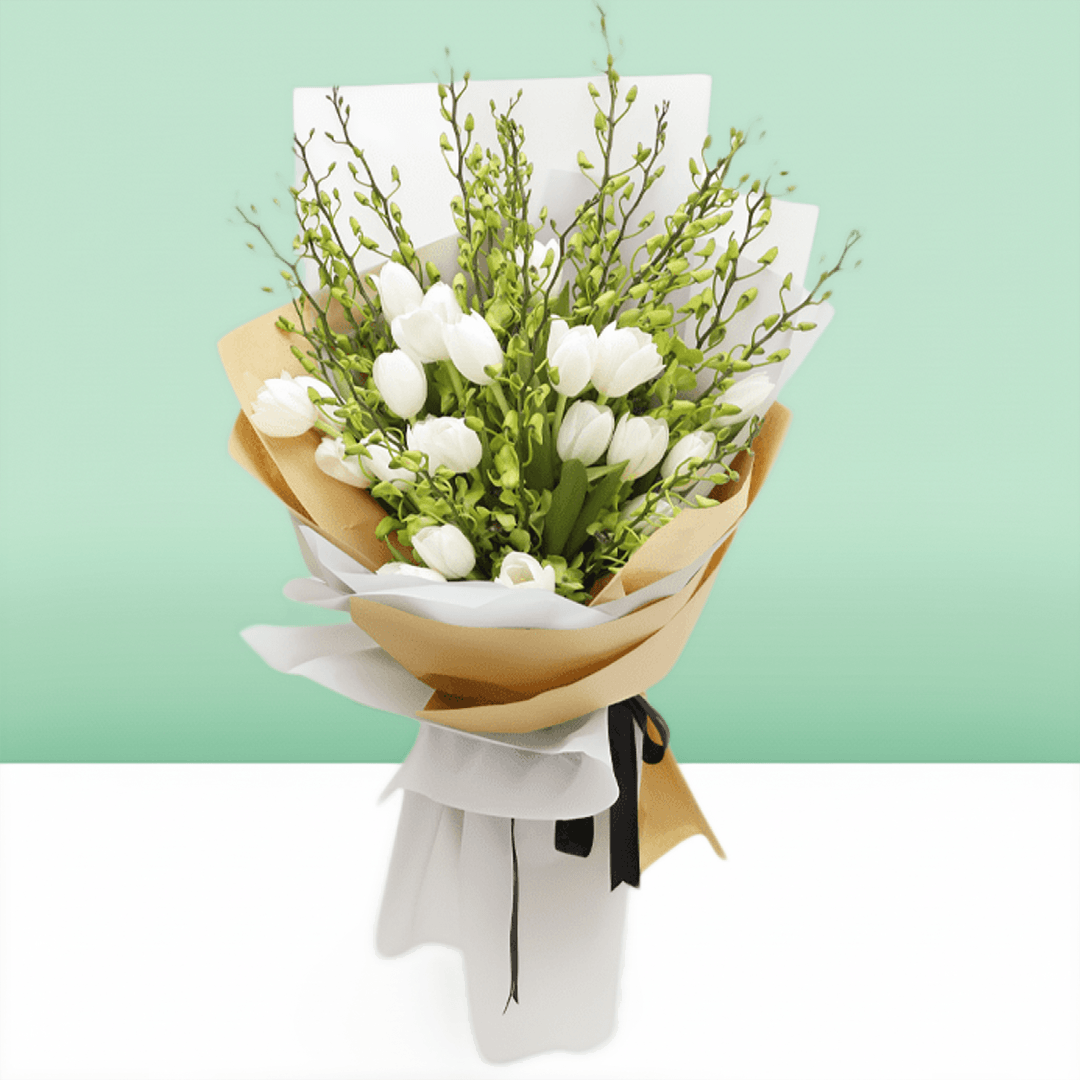 White tulips and orchid stems arranged with greenery in white and natural-toned wrapping
