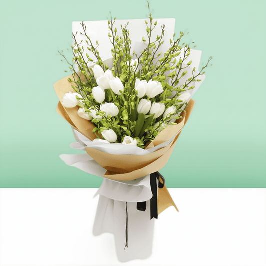 White tulips and orchid stems arranged with greenery in white and natural-toned wrapping
