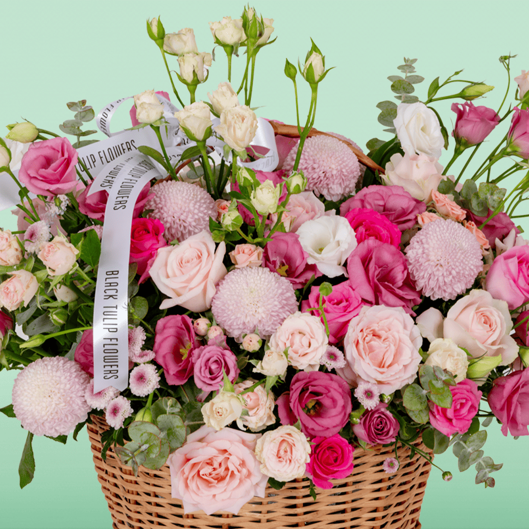Grand flower basket arranged with Roses, Spray Roses, Eustoma, Ball Chrysanthemums and fresh Eucalyptus.

