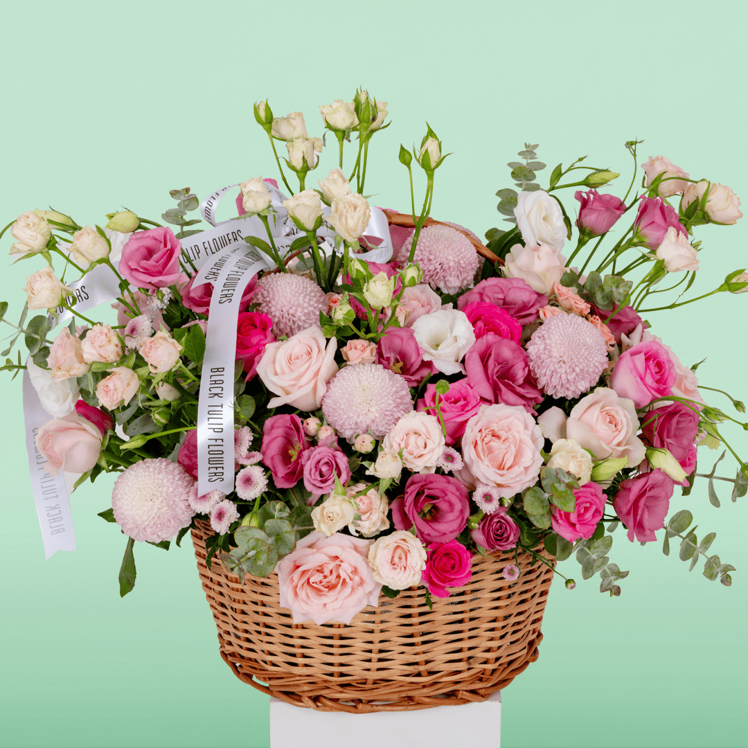 Grand flower basket arranged with Roses, Spray Roses, Eustoma, Ball Chrysanthemums and fresh Eucalyptus.