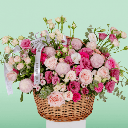 Grand flower basket arranged with Roses, Spray Roses, Eustoma, Ball Chrysanthemums and fresh Eucalyptus.