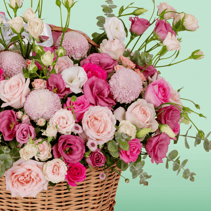 Grand flower basket arranged with Roses, Spray Roses, Eustoma, Ball Chrysanthemums and fresh Eucalyptus.