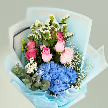Pastel blue hydrangea bouquet with fresh blooms arranged elegantly for gifting