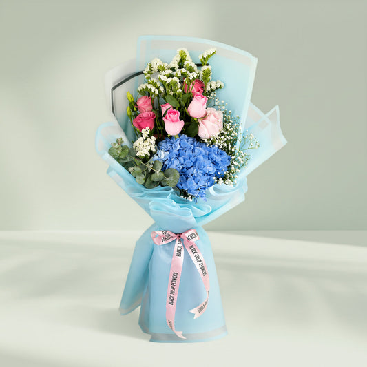 Pastel blue hydrangea bouquet with fresh blooms arranged elegantly for gifting