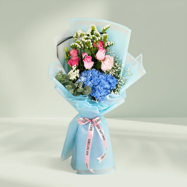 Pastel blue hydrangea bouquet with fresh blooms arranged elegantly for gifting