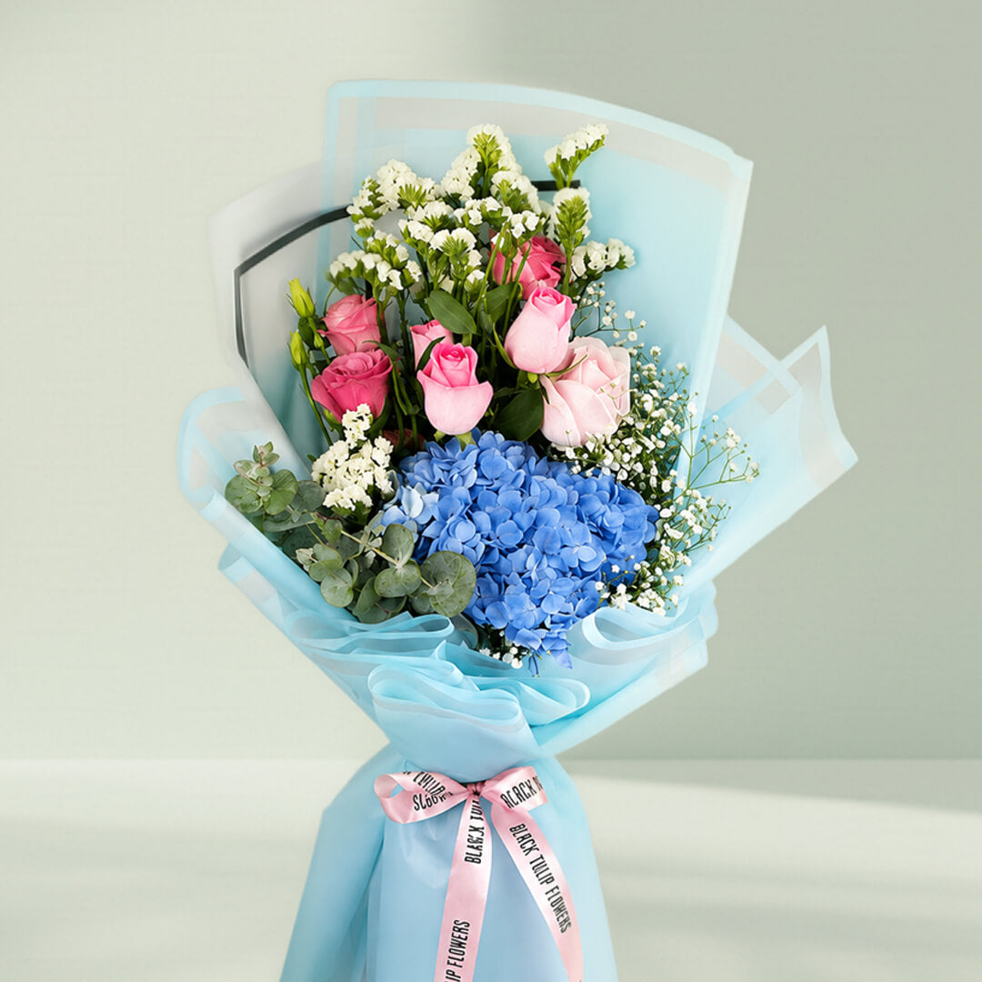 Pastel blue hydrangea bouquet with fresh blooms arranged elegantly for gifting