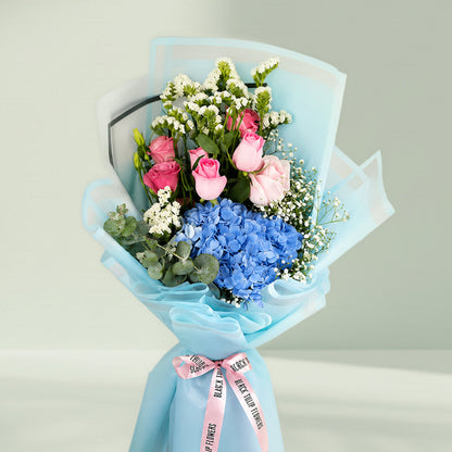 Pastel blue hydrangea bouquet with fresh blooms arranged elegantly for gifting