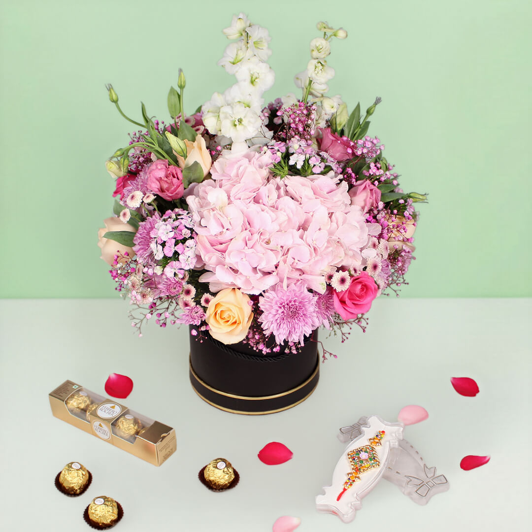 Pastel flower box with Rakhi and Ferrero Rocher chocolates for Raksha Bandhan gift