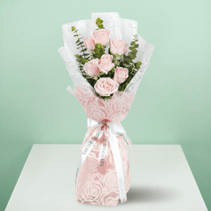 7 pink roses bouquet with eucalyptus in pink wrapping