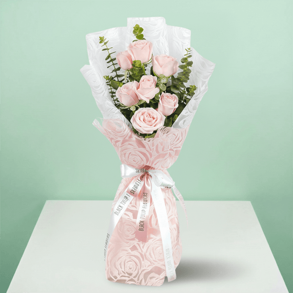 7 pink roses bouquet with eucalyptus in pink wrapping