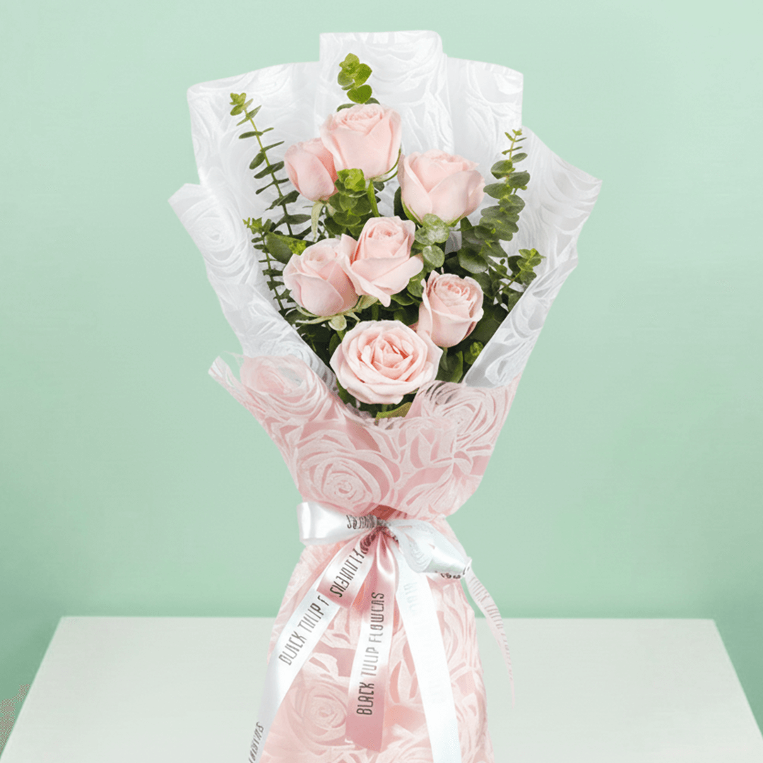 7 pink roses bouquet with eucalyptus in pink wrapping