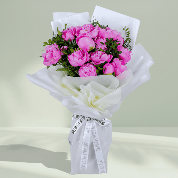Pink peonies with greenery wrapped in elegant white.