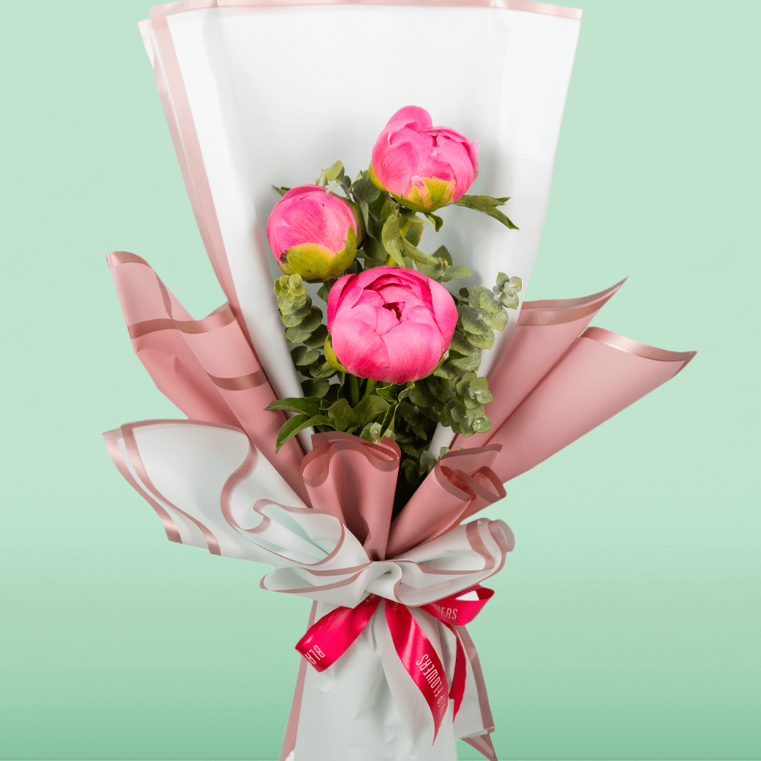 Pink peony bouquet featuring three blooms, fresh greenery and Korean flower wrapping sheets.