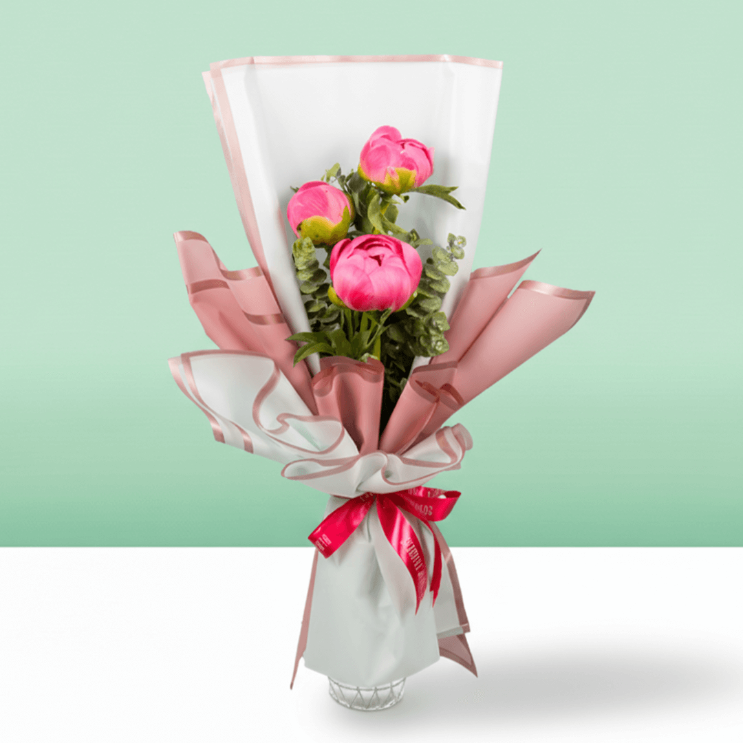 Pink peony bouquet featuring three blooms, fresh greenery and Korean flower wrapping sheets.
